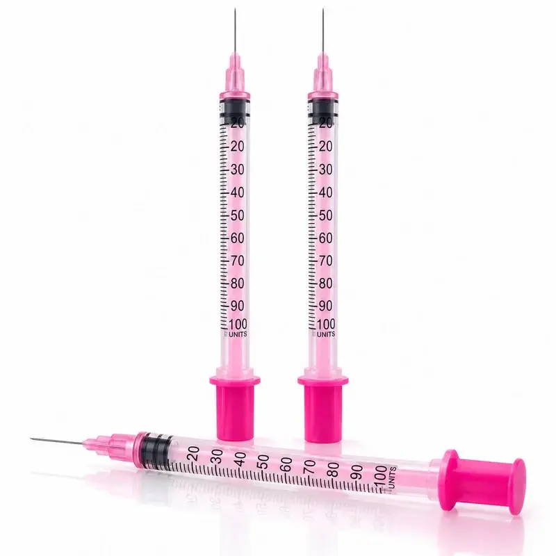 Three insulin syringes with pink plungers and 100 unit markings on a white background